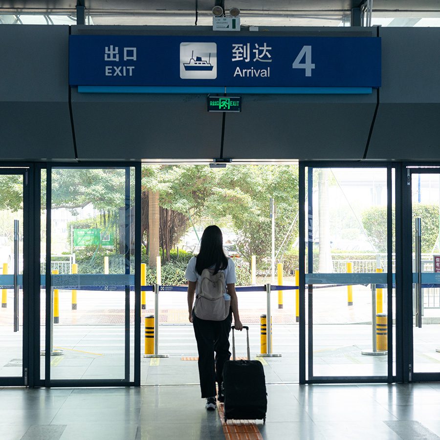 Woman leaving Shenzhen airport ferry terminal