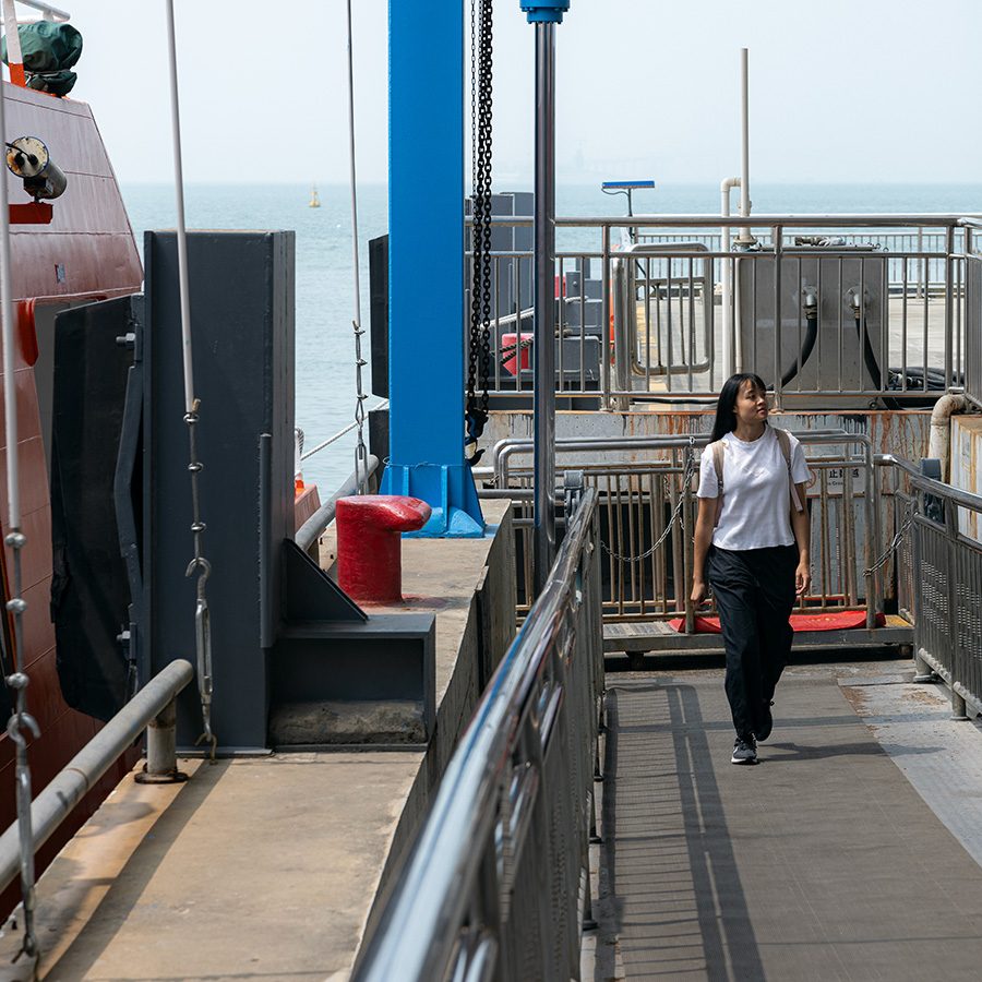 Woman walking along pier