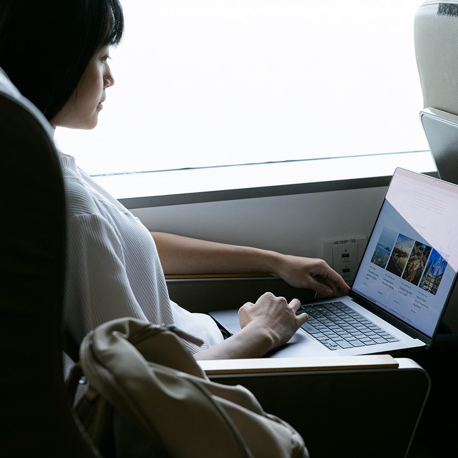 Woman using laptop on ferry to shenzhen