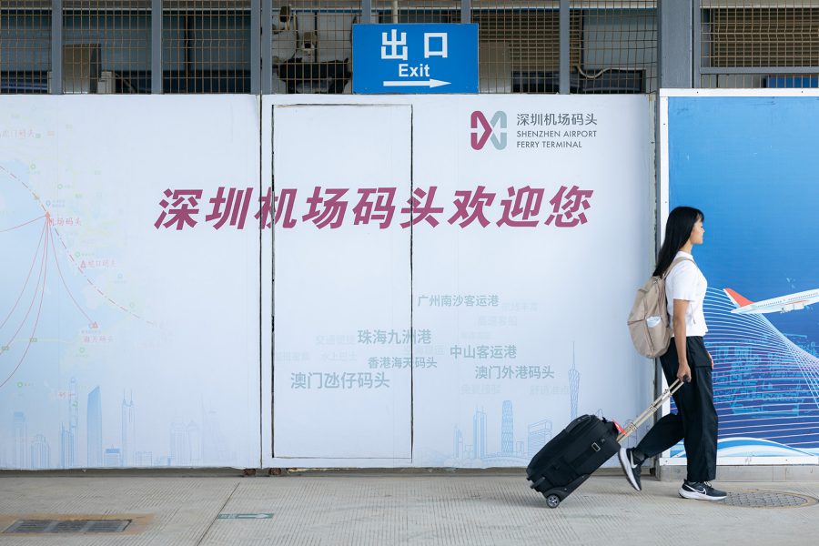 Woman walking away from Shenzhen airport ferry terminal