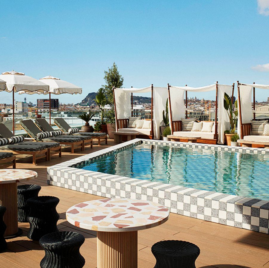 The Hoxton, Poblenou pool and deckside with chairs and umbrellas