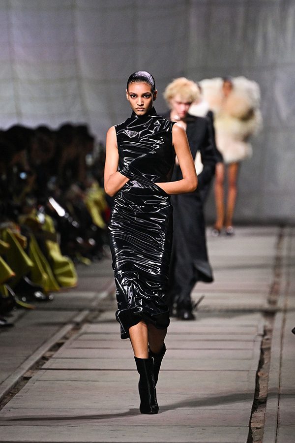 Model wearing black dress at a Alexander McQueen runway