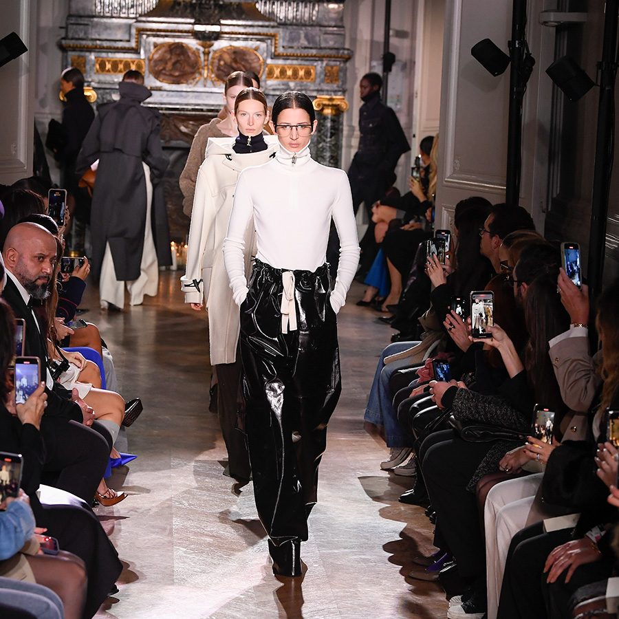 Model wearing white top and black pants at a Victoria Beckham runway
