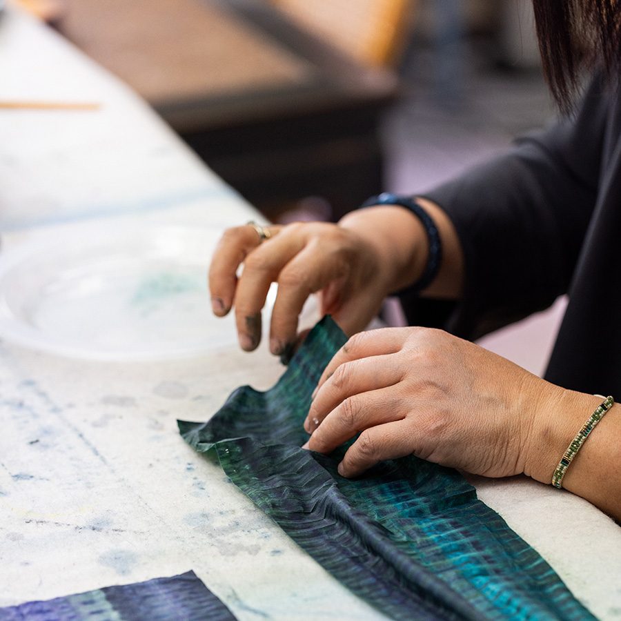 Hands holding blue cloth