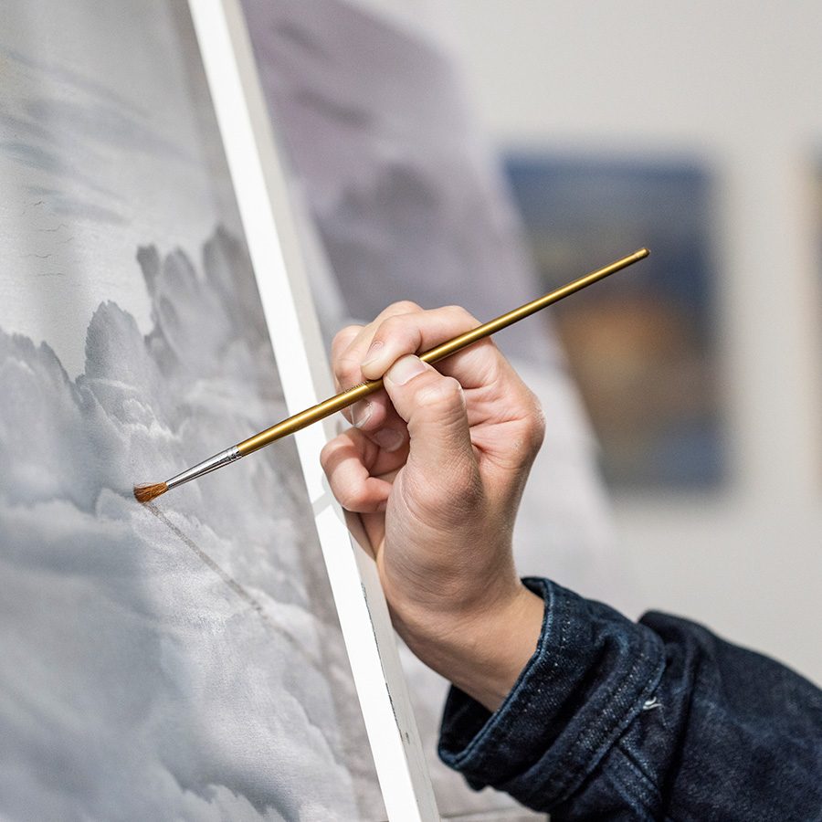 A closeup of Landscape painter Lau Yin Yeung's hand when he is drawing