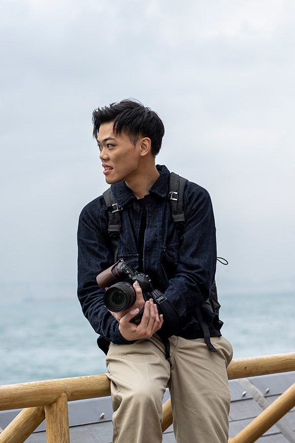 Landscape Painter Lau Yin Yeung with his camera and looking to the sea