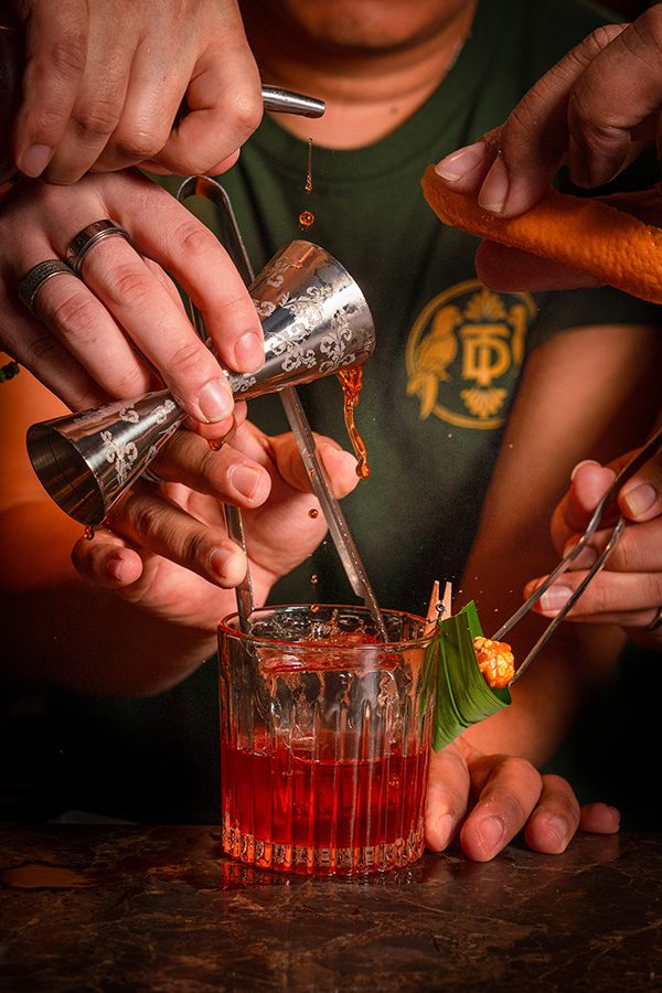 Hands pouring into drink