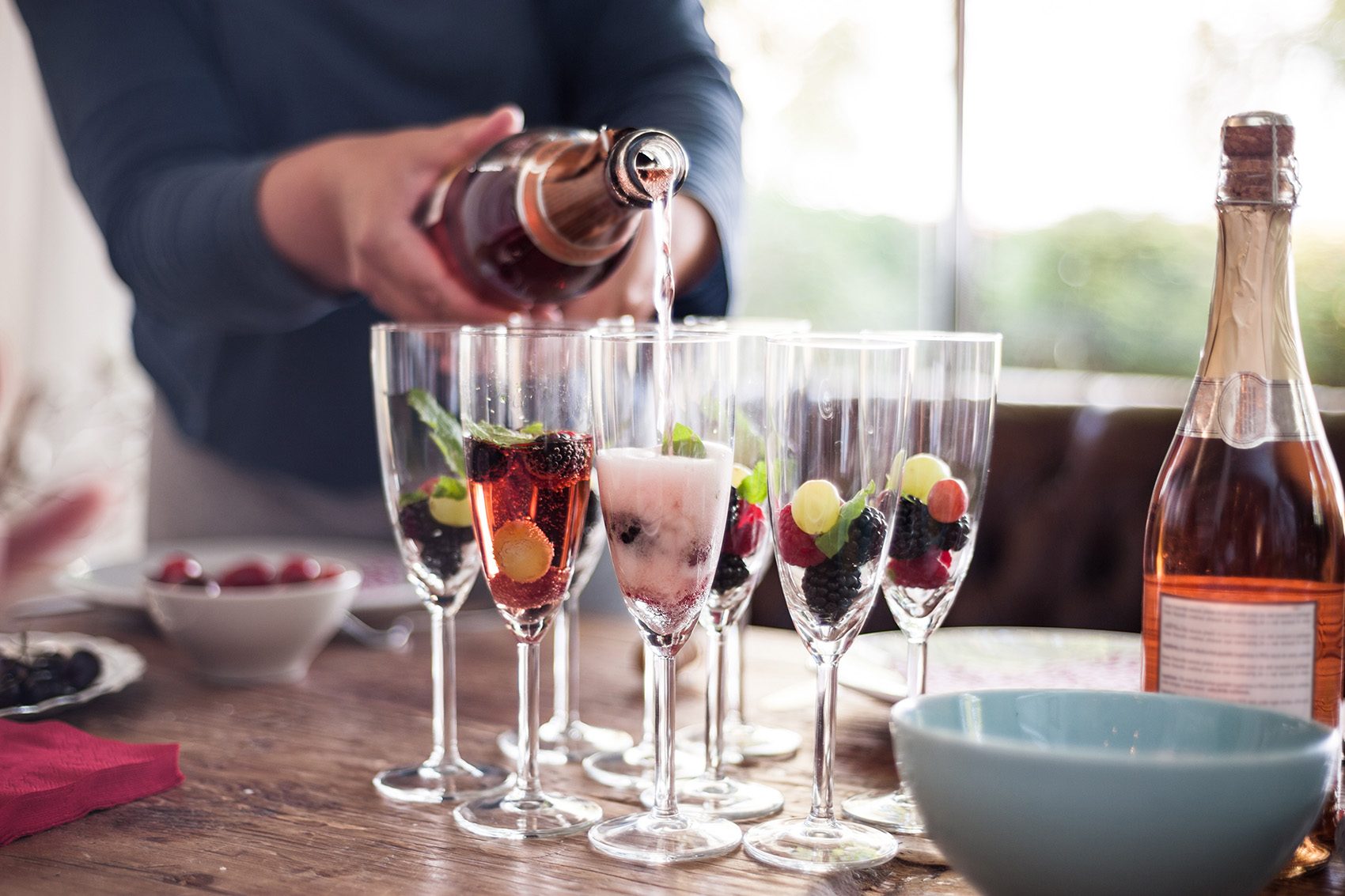 Man pouring alcohol into glasses