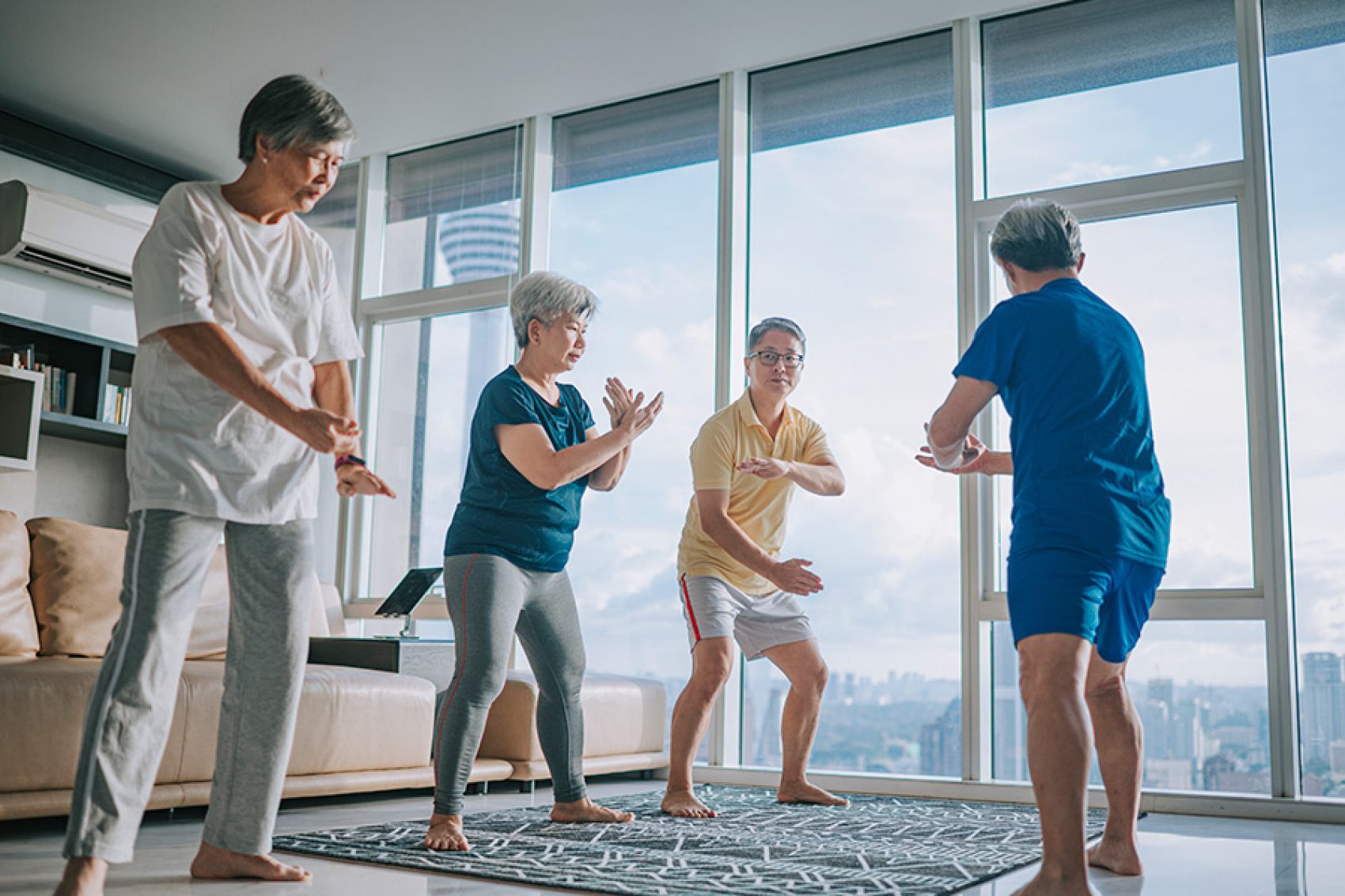 A man teaching his elderly friends tai chi