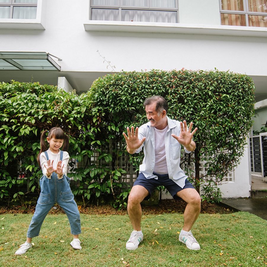 A man and his granddaughter doing tai chi