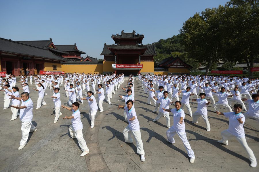 A group of people practicing tai chi together