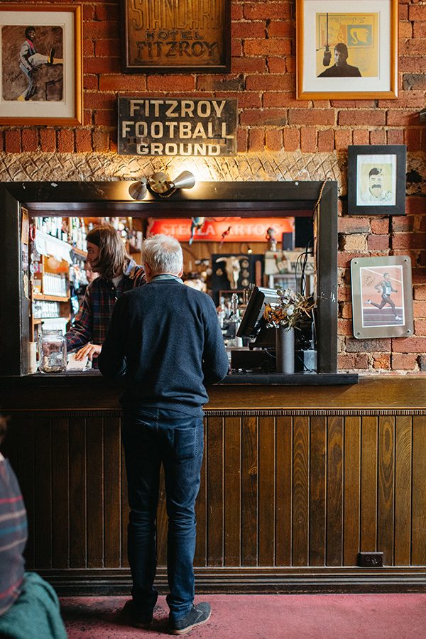 An elderly man standing at the counter of the pub The Standard Hotel in Fitzroy