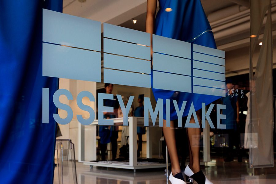 View of the Issey Miyake store window displaying the brand logo 