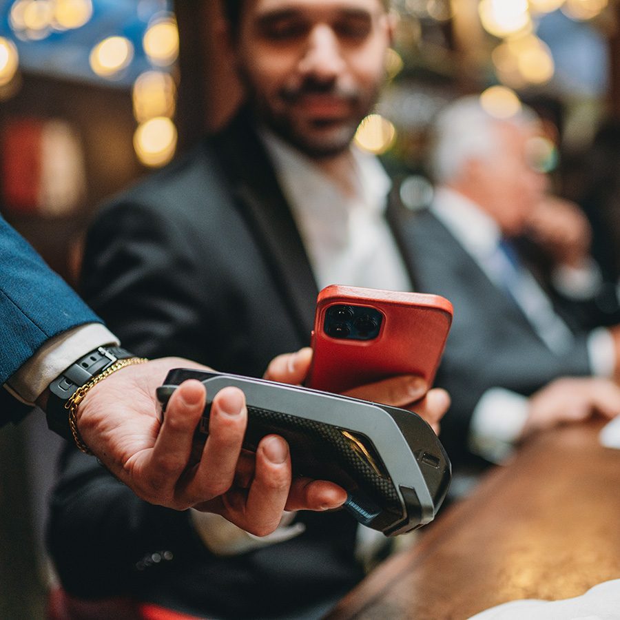 Man paying the bill with a red phone