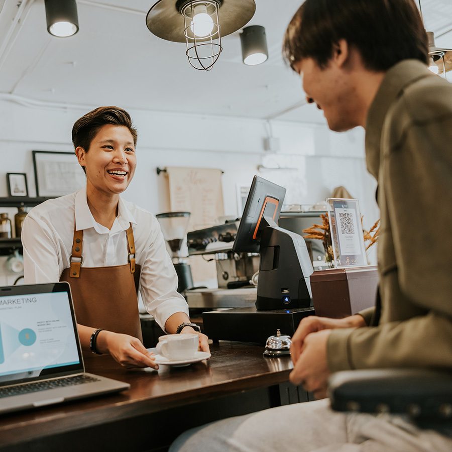 Man paying for a cup of coffee at the counter