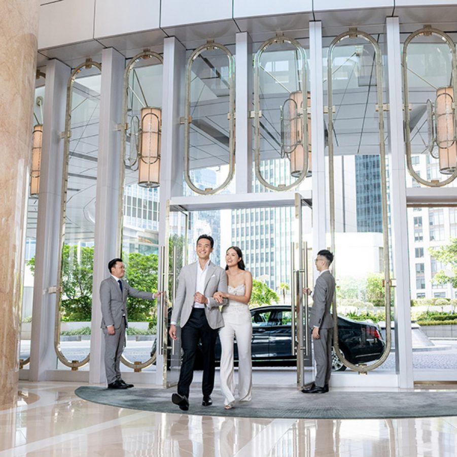 Man and woman walking into hotel lobby