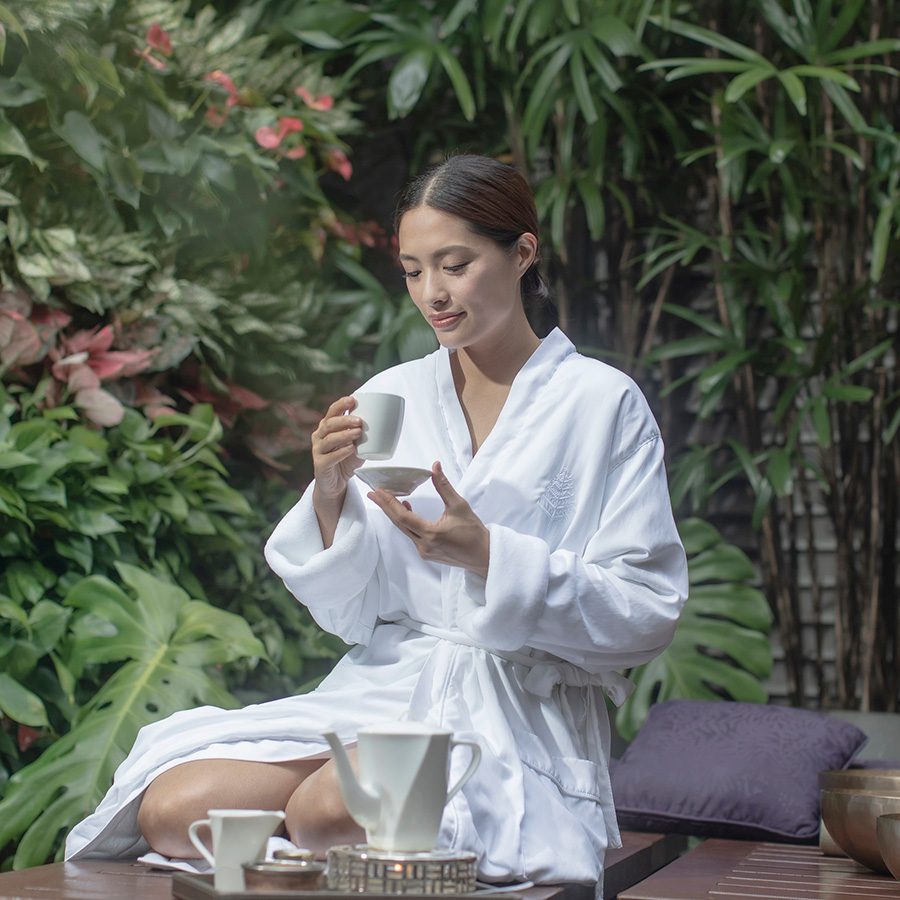 A woman sitting outside with tea