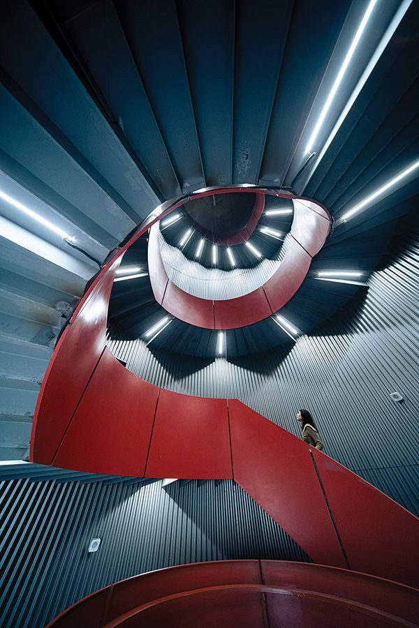 Woman walking up abstract stairs