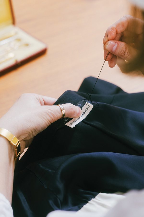 Sewing label onto upcycled clothes