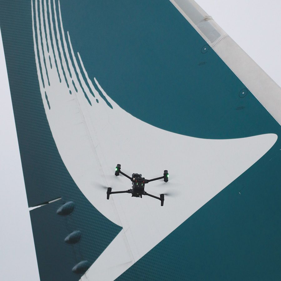 Cathay Pacific logo on tail fin with drone flying over it