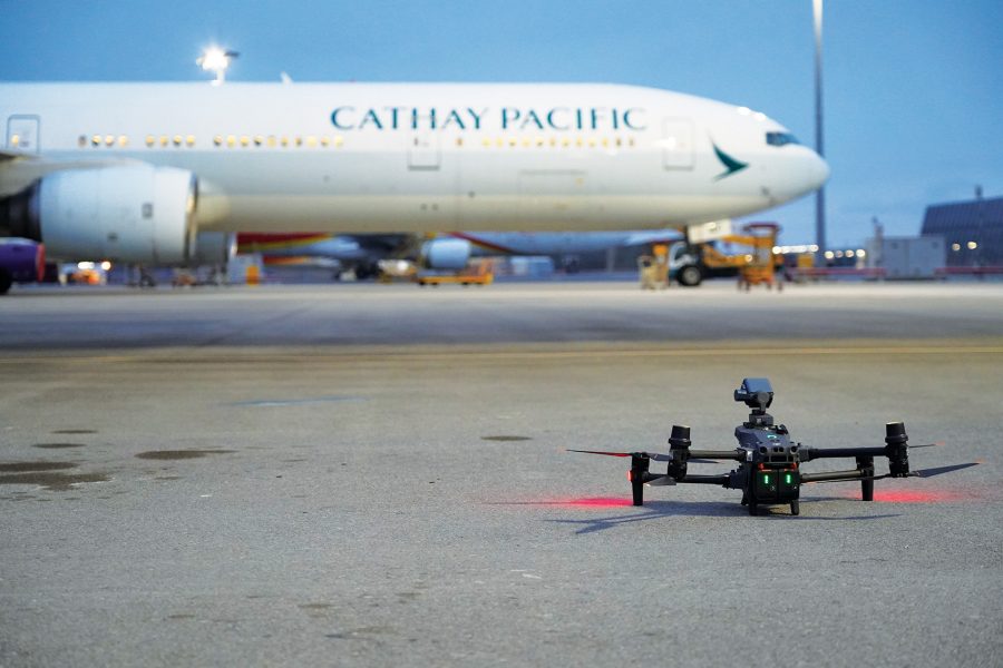 Cathay Pacific aircraft with a drone next to it on the tarmac