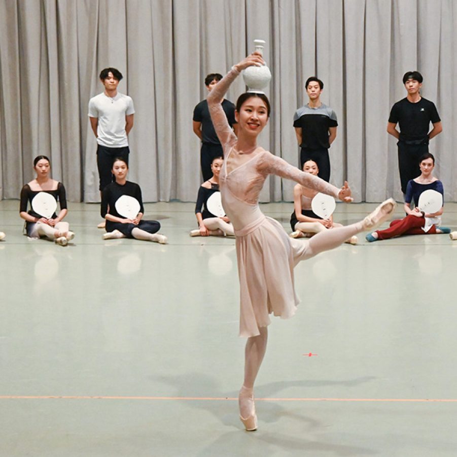 Hong Kong Ballet dancer Peggy Lai rehearsing a dance routine with a vase on her head