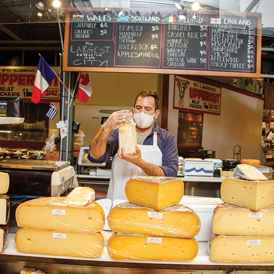 A man selling cheese at St. Lawrence Market in Toronto