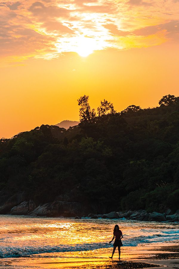 Woman on beach during sunset