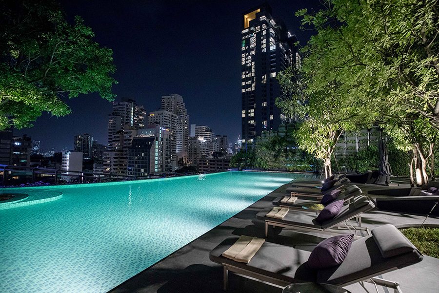 Hyatt Regency Bangkok Sukhumvit's outdoor pool with lounge chairs for lounging.