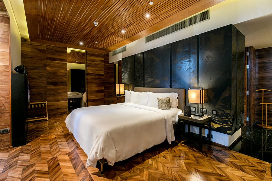 SO Bangkok's bedroom comes with a large double bed and elegant décor.