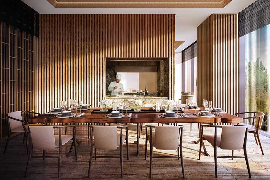 Aman Nai Lert Bangkok's restaurant has an open kitchen with a chef cooking. 