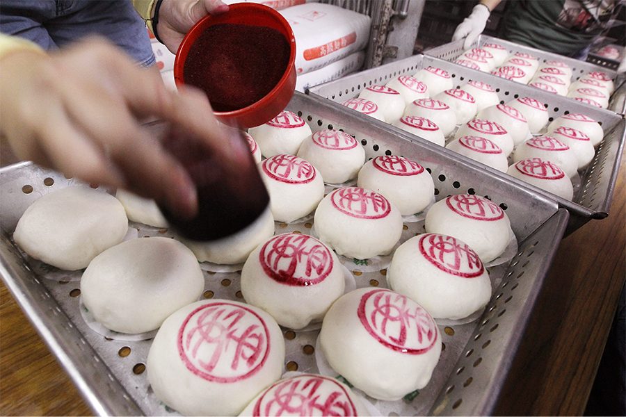 Bau buns being stamped at Cheung Chau bun festival
