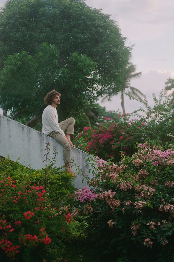 FKJ on wall surrounded by flowers