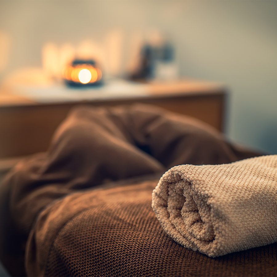 Spa treatment room lit by candle