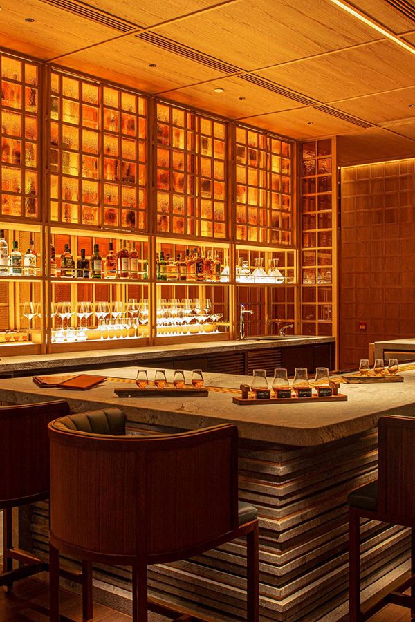 Uncle Ming's elegant dining area with warm lighting and a well-stocked bar