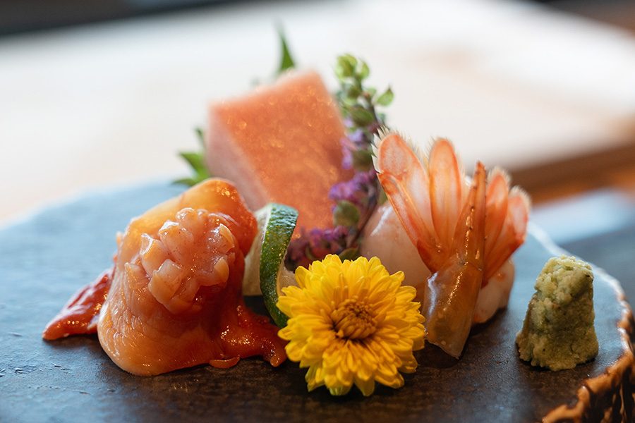 Gonpachi sashimi beautifully presented with floral decoration