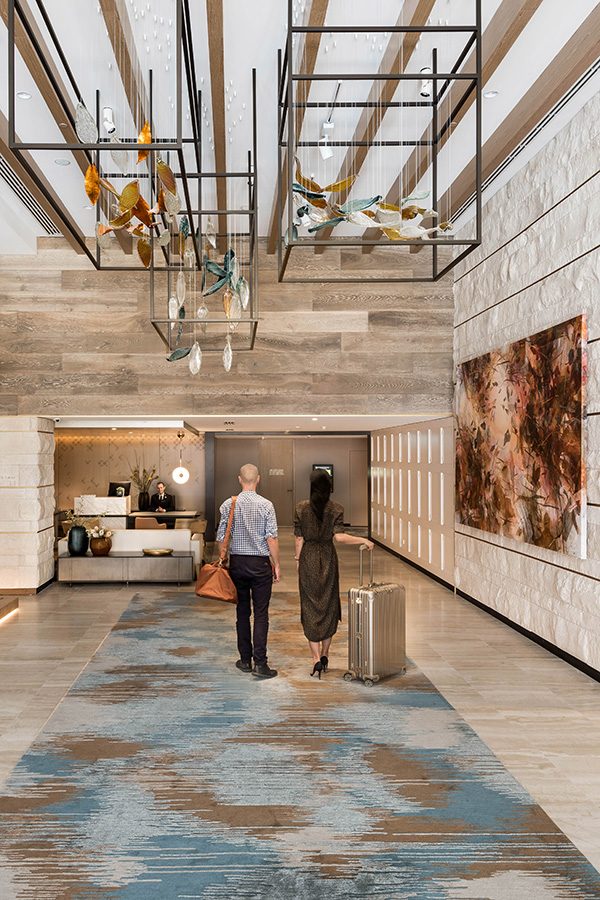 Guests walk to the front desk 