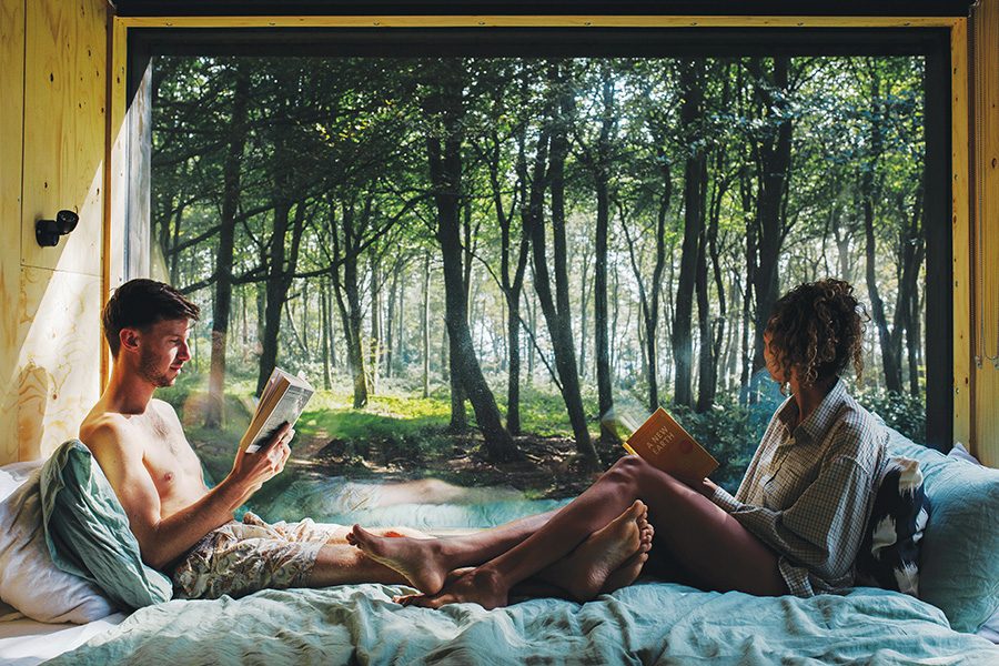 A couple reading together in an Unplugged cabin