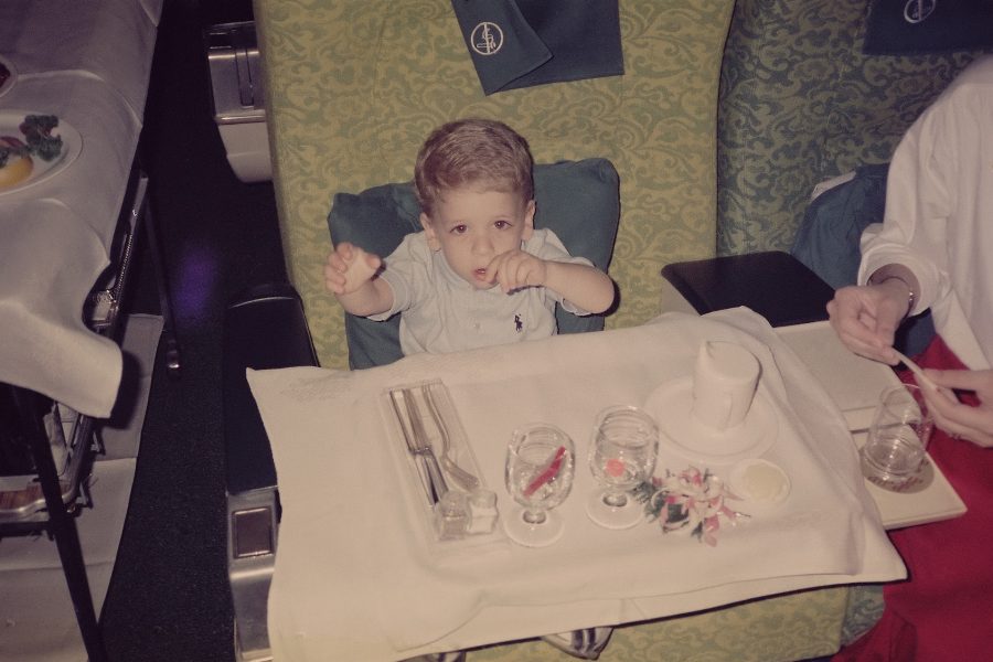 A baby is sitting and looking at the camera