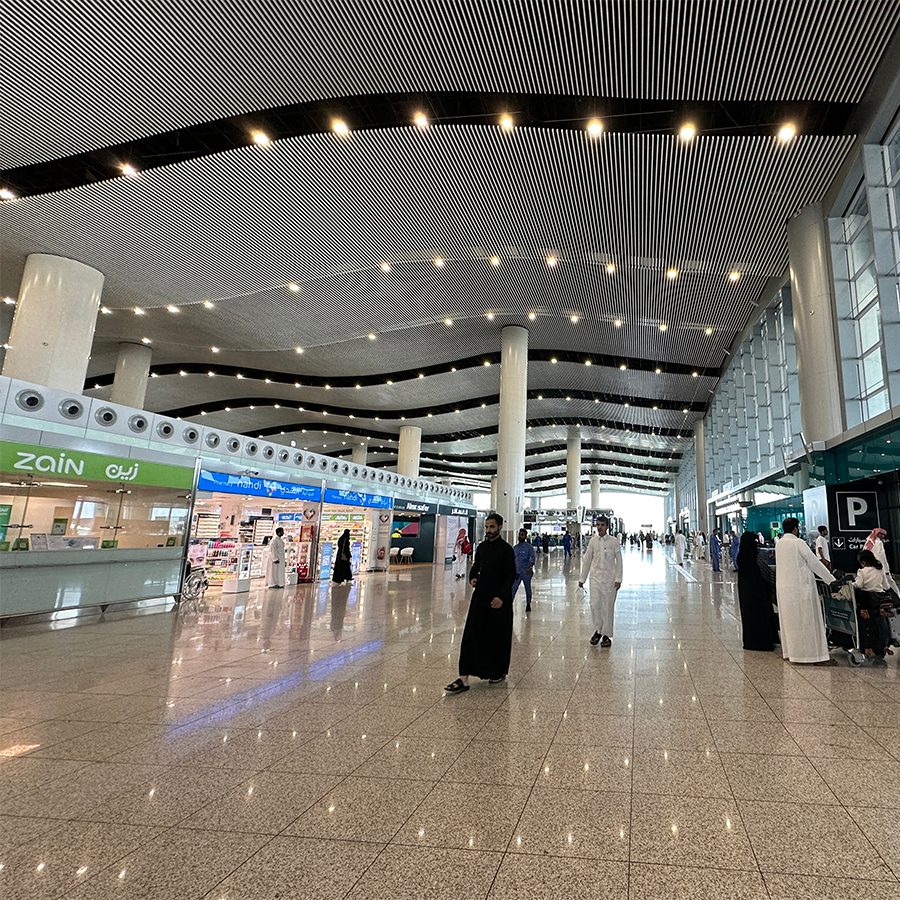 People walking through King Khalid International Airport.