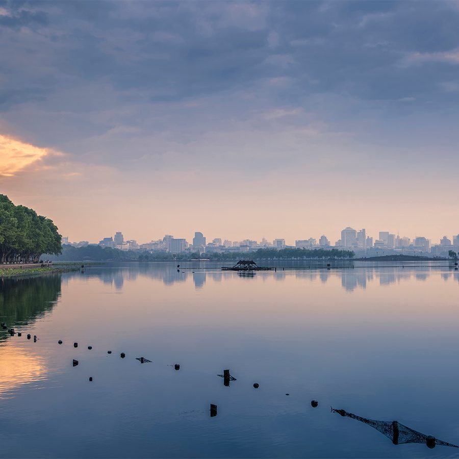 A wide shot view of West Lake in Hangzhou under cloudy weather.