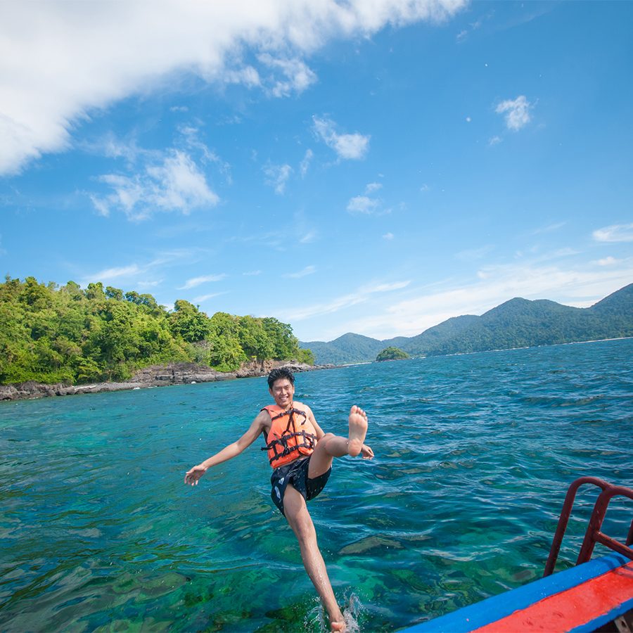 A man jumping off from a boat