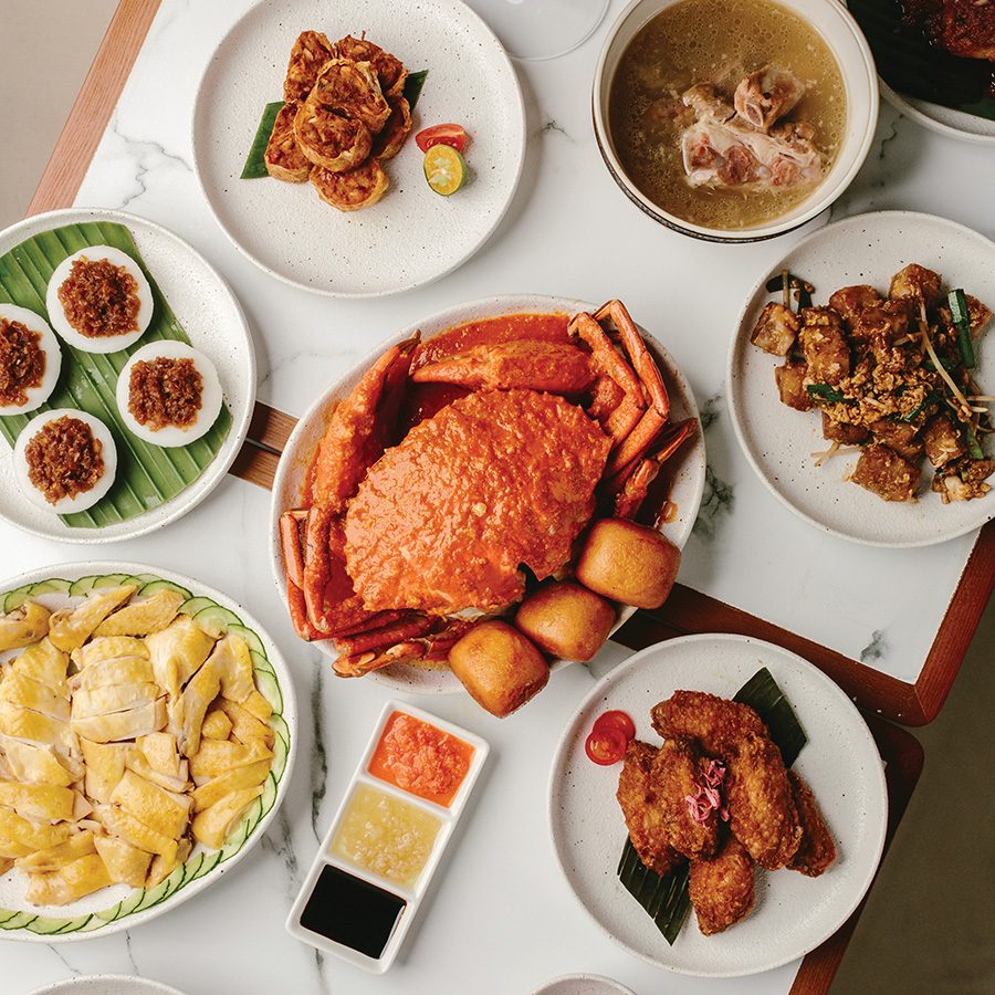 A spread of different dishes at Jom - Hainese chicken rice, chili crab, fried chicken, soup
