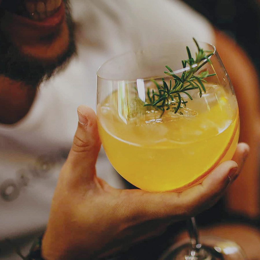 A man is having a yellow cocktail in an elaphanta.
