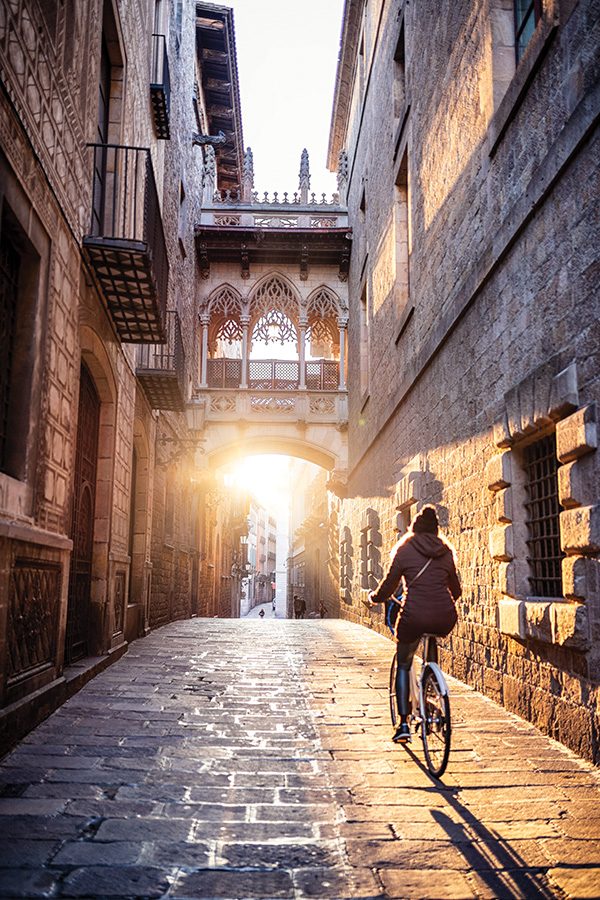 A person is riding a bike on the Famous Bridge