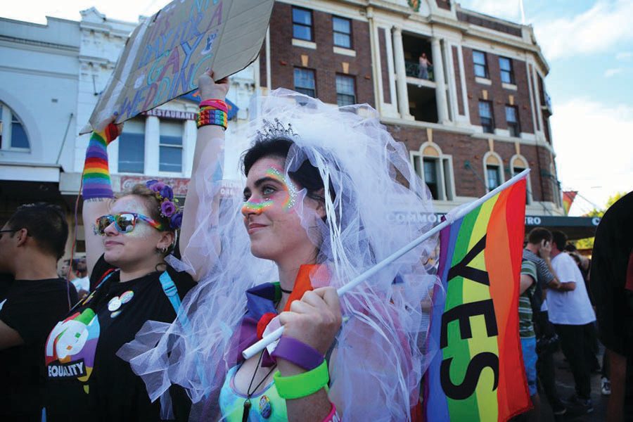 Woman holding up pride flag