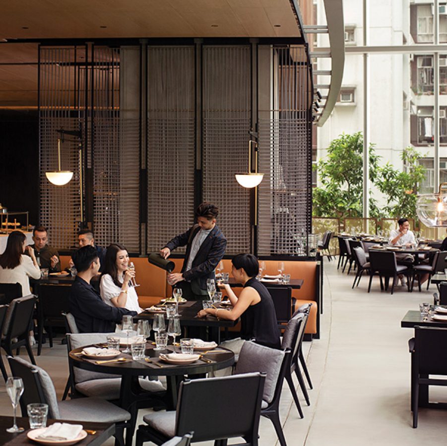 A group sitting at a table sipping tea at East Hotel’s Feast 