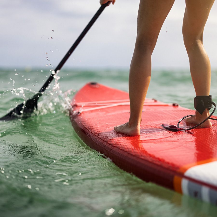A teenage girl is enjoying the SUP paddleboard