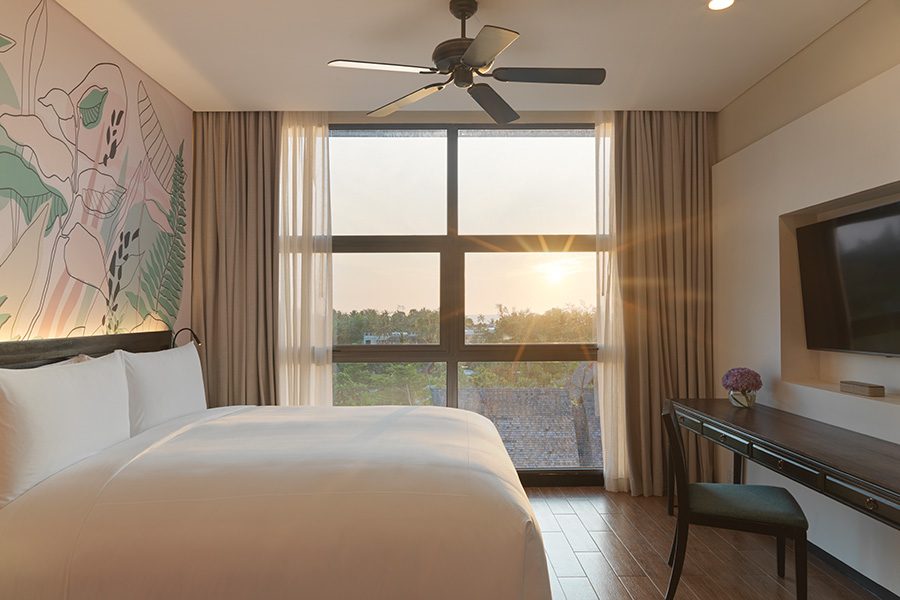 The view of the sunset from inside the bedroom in Avani+ Mai Khao Phuket