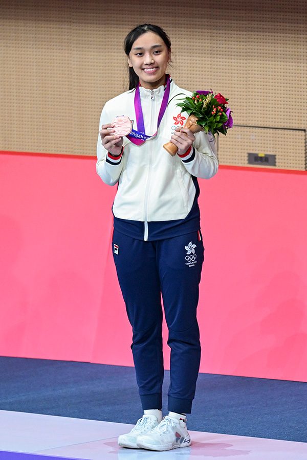 Chan Nok Sze stands on the podium.